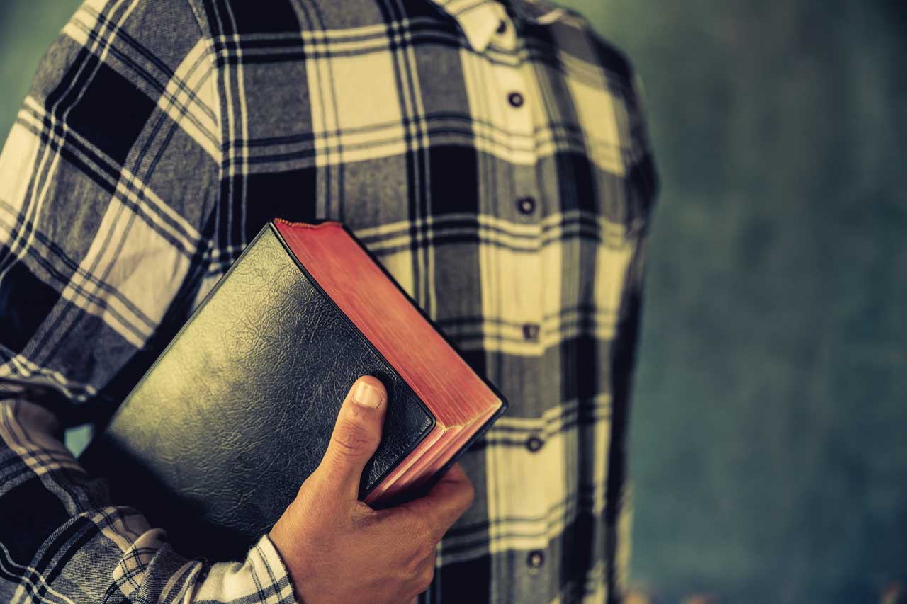 young-man-holding-bible-in-his-hands